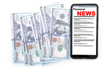 Fototapeta premium The smartphone on the screen the inscription financial news lies on dollars. 100 dollars banknotes and smartphone with financial news.