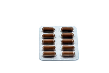 Pills in packaging on a surface isolated on white background.