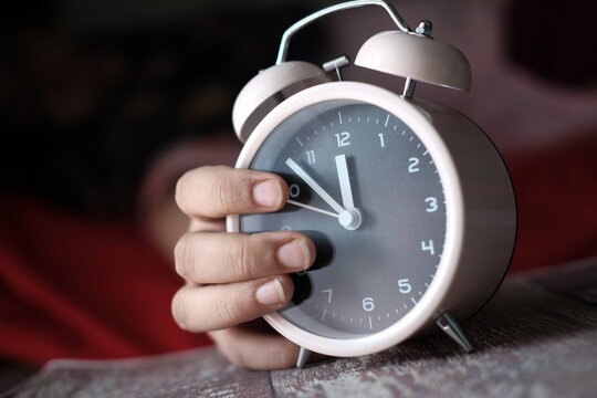 Women Hand Stopping Alarm Clock