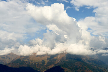 Nature and travel concept - High mountain and sky with clouds in autumn. Beautiful landscape