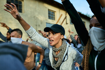 Angry female activist shouting while participating in public demonstrations.
