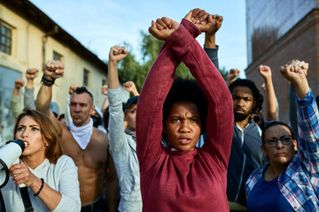 African American woman with arm-crossing gesture on public demonstrations.
