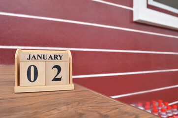 January 2, Number cube with wooden table beside the wall.