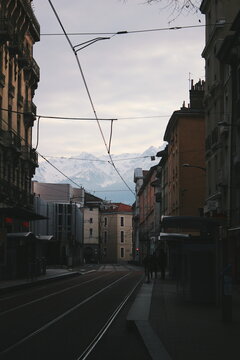 tram in the city of Grenoble and view of mountain Alps 