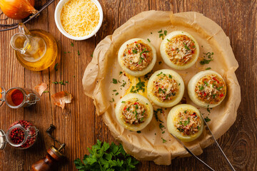Onion baked with cheese stuffed with minced meat. Top view.  Served in parchment.