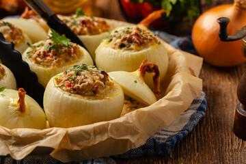 Onion baked with cheese stuffed with minced meat. Front view.  Served in parchment.