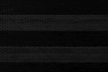 Black brick wall. Facade of an old building. Architectural background.