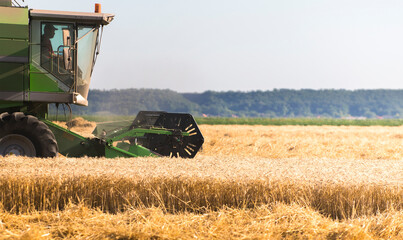 Harvester at work in summer sun