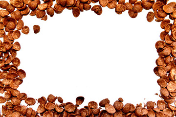 Frame of chocolate corn flakes isolated on white background.
