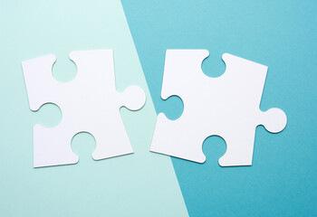 empty white big puzzles on a blue background. Concept in business, close up