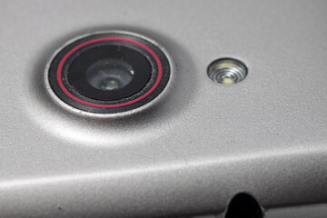 Macro shot of a smartphone camera on a white isolated background