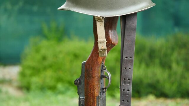 Memorial battlefield cross. Symbol of a fallen US soldier. M1 rifle with helmet.