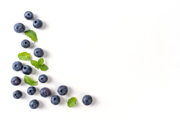 Blueberry fruit top view isolated on a white background, flat lay overhead layout with mint leaf, healthy design concept.