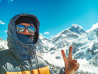 Hiker making selfie at Beautifull Everest and Nuptse mountains landscape from the footpath on the Everest Base Camp trek in the Himalaya, Nepal. Everest and Lhotse view.