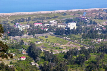 Fototapeta na wymiar View of Gonio Apsaros Fortress, Black Sea beach and surrounding apartment buildings. Georgia, Gonio