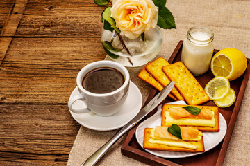 Healthy breakfast. Cup of coffee (black tea), milk, crackers with butter and salmon