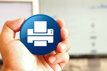 Printer icon blue round button holding by hand infront of workspace background