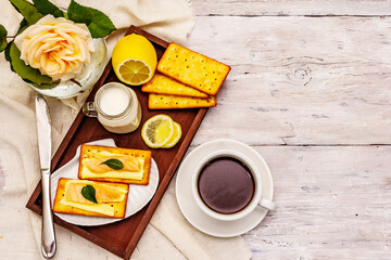 Fototapeta na wymiar Healthy breakfast. Cup of coffee (black tea), milk, crackers with butter and salmon