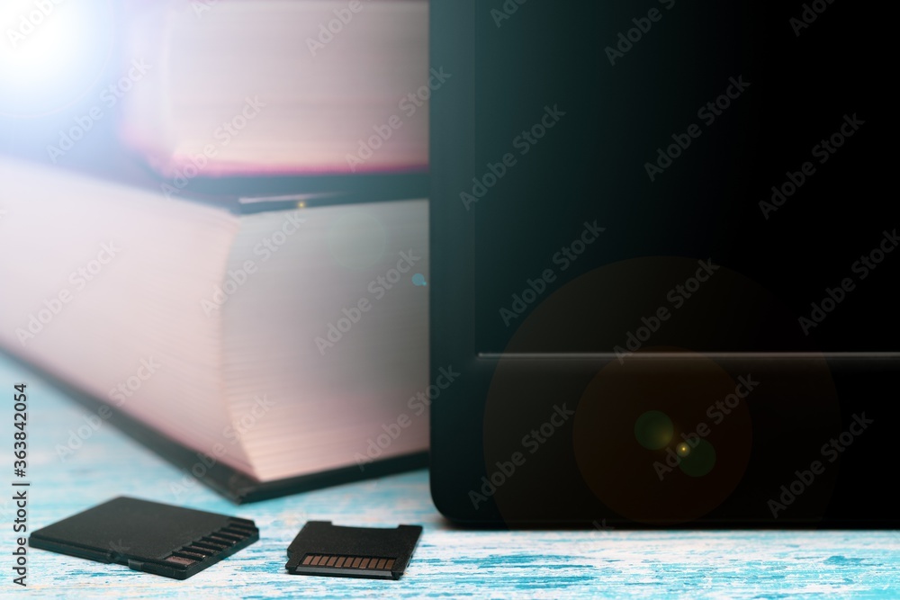 Poster modern e-book and small memory cards with books in the background