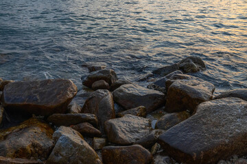Fototapeta na wymiar Large stones on the seashore washed by water