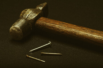  Old hammer and nails on dark background