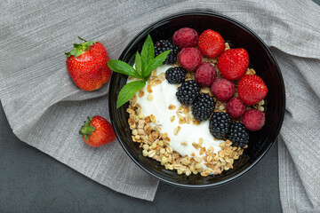 Smoothie bowl with granola, strawberry, raspberry and blackberries, top view. Superfood. Concept of healthy eating, healthy lifestyle