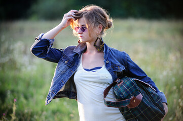 Vintage way dressed yang beautiful woman walks outdoor in summer time.