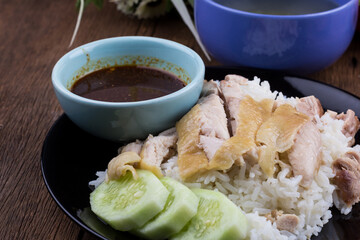 Thai food gourmet steamed chicken with rice , khao mun kai in wood background