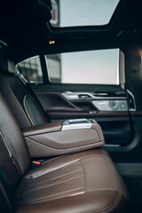 Luxury car rear seat row with armrest