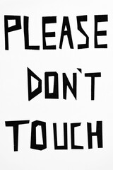 Obraz premium White wall with Please Don't Touch sign as written instruction