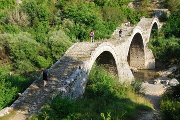 The traditional three-arched stone-made bridge Kalogeriko at Kipoi village, one of the 45 villages...