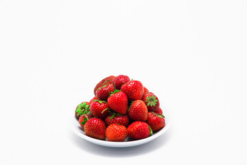 ripe strawberries in a glass bowl. on a white background