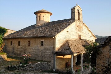 Fototapeta na wymiar The traditional stone-made monastery of Evaggelistria at Ano Pedina village, one of the 45 villages known as Zagoria or Zagorochoria in Epirus region of southwestern Greece, August 9 2010.