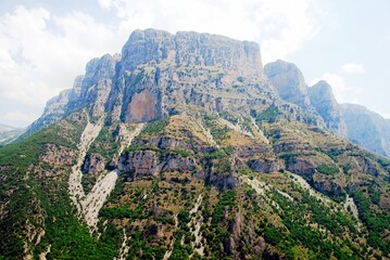 Fototapeta na wymiar Panoramic view of Tymfi Mountain and Vikos gorge from Vikos village. Zagoria area, Epirus region, northwestern Greece.