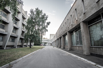 KIEV, UKRAINE - JULY, 2020: Empty courtyard of Taras Shevchenko National University of Kyiv. Courtyard of obsolete gray concrete buildings in the style of modernism.
