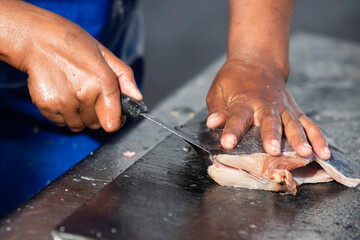 Fresh fish being cut, filleted and prepared