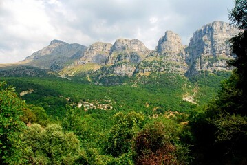 Fototapeta na wymiar Panoramic view of Tymfi Mountain and Mikro Papigko village, one of the 45 villages known as Zagoria or Zagorochoria in Epirus region of southwestern Greece.