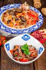 Baked eggplant salad with vegetables in a plate with a pattern