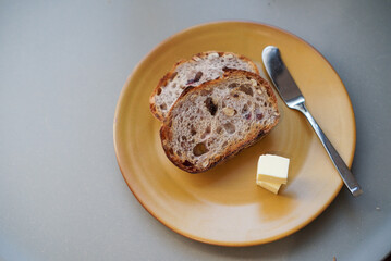 Cranberry wheat bread. Two slice of wheat bread with cranberry, raisin and walnut, served with butter. (top view)