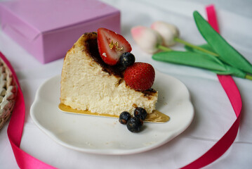 Berry Cheesecake. A sliced cheesecake with lava texture, topped with blueberry and strawberry. (Isolated)