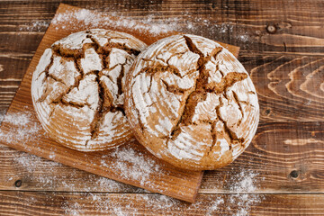 fresh baked bread loafs on the wooden background
