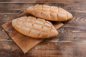 fresh baked bread loafs on the wooden background