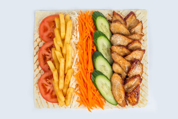 Shawarma filling on a white plate under cutting