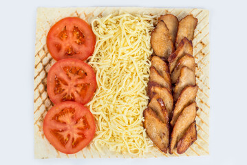 Shawarma filling on a white plate under cutting