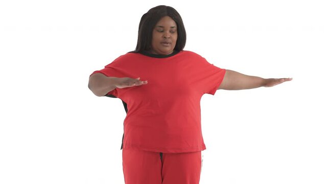portrait of black plus size model doing cooldown stretching exercise isolated on white background