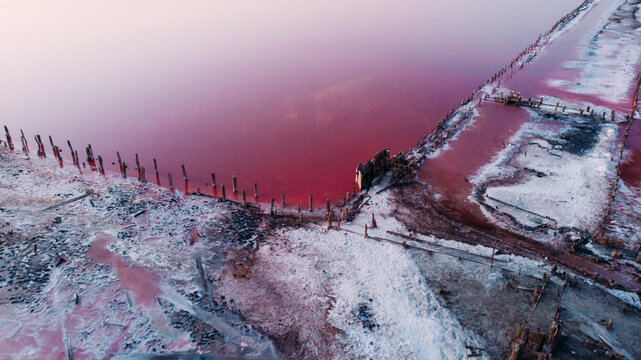 View from drone above the pink salty lake and salt mining.