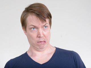 Face of stressed young man looking scared