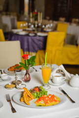 Breakfast for two in empty restaurant.  Mozarella with salmon and salad. Social distancing