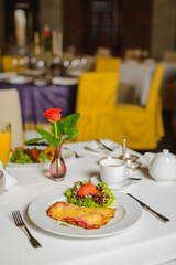 Bread with fried bacon and cheese. Breakfast in empty restaurant. Social distancing