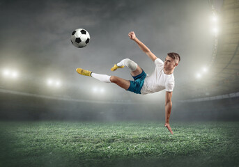 Fototapeta na wymiar Soccer player on a football field in dynamic action at 
